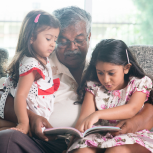 Grandfather Reading to Two Small Girls